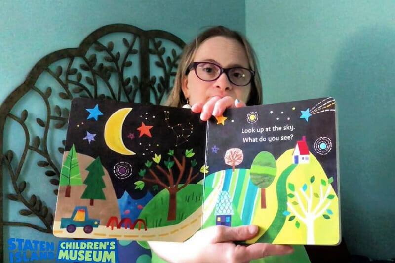 Jackie reading a book in a story time video.