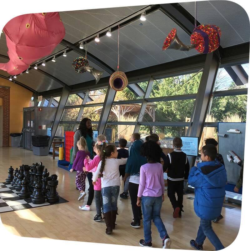 children walking in big games exhibit.