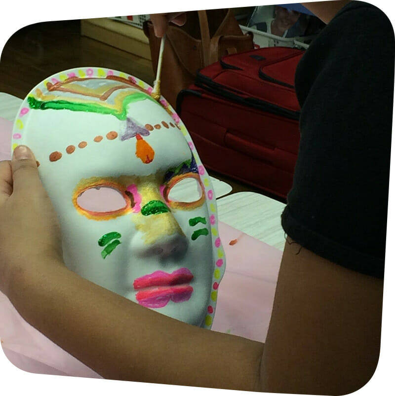 child painting colorful mask