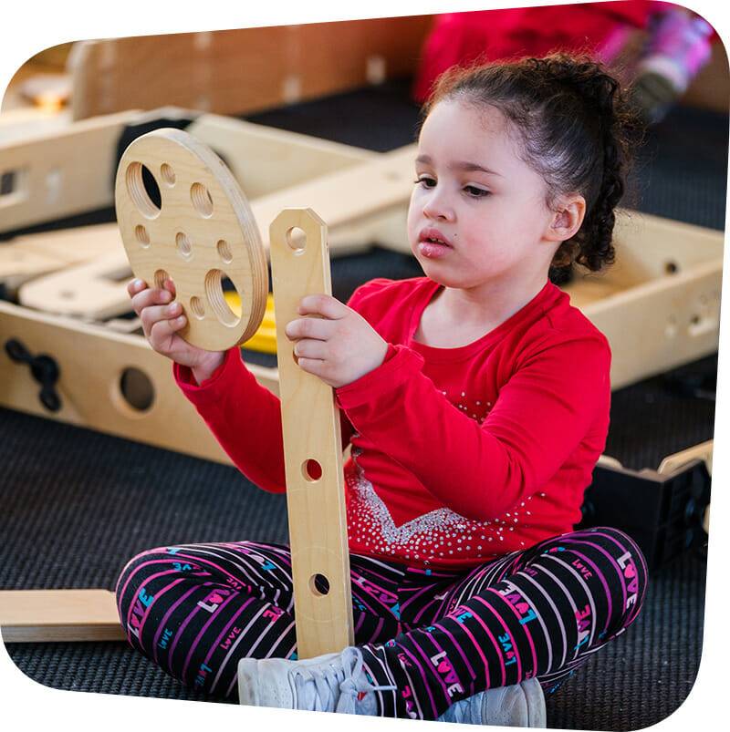Child playing with wooden pieces.