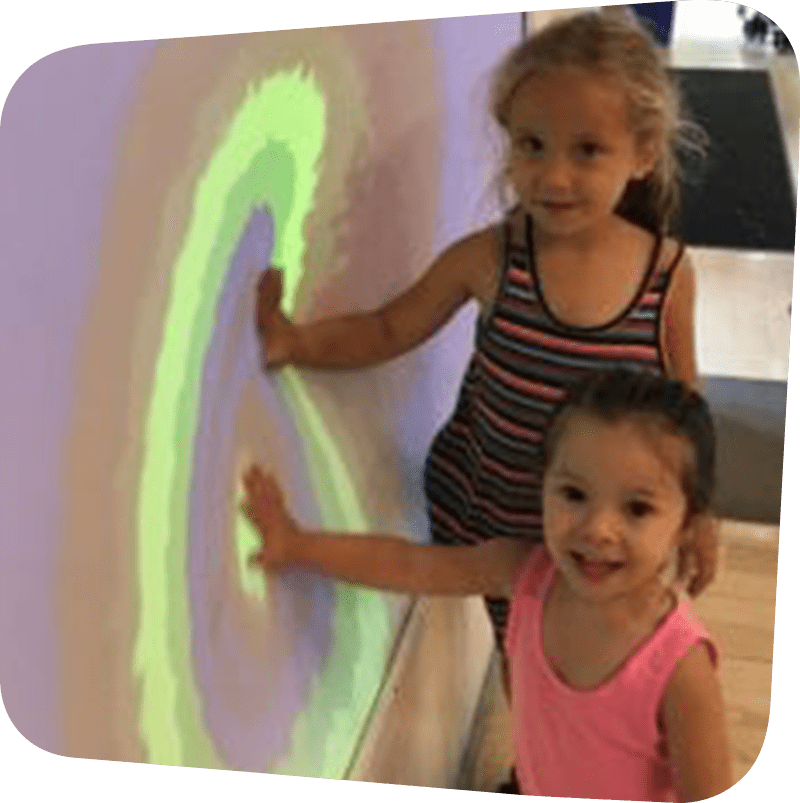 SICM_0000_Sensory-Imaging-236x300 two children touching colorful wall