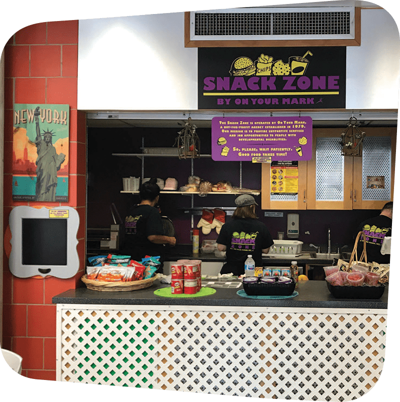 Snack Zone employees working behind the Snack Zone counter.