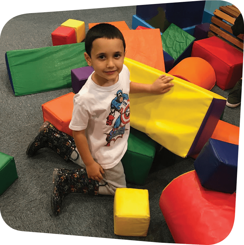 Child playing with colorful foam blocks