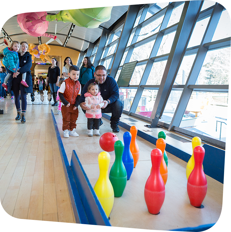 children and adult bowling in big games exhibit