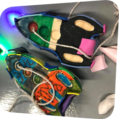 2 toy rocket ships with LED lights