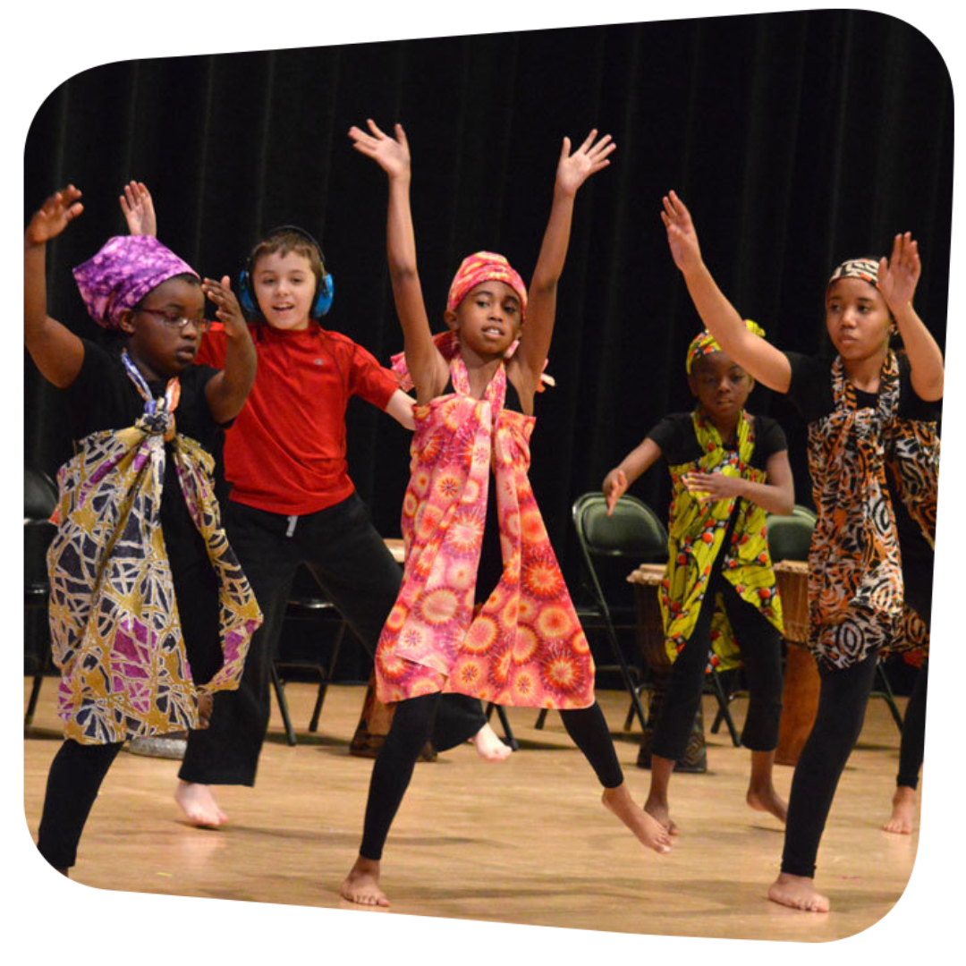 children preforming Kwanzaa dance on stage
