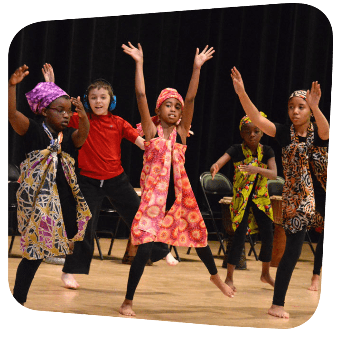 children preforming Kwanzaa dance on stage