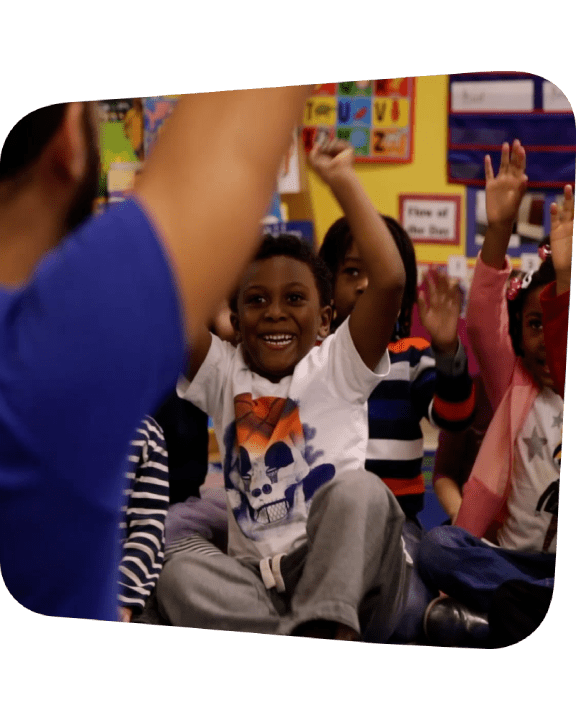 Kids raising their hands in cheer