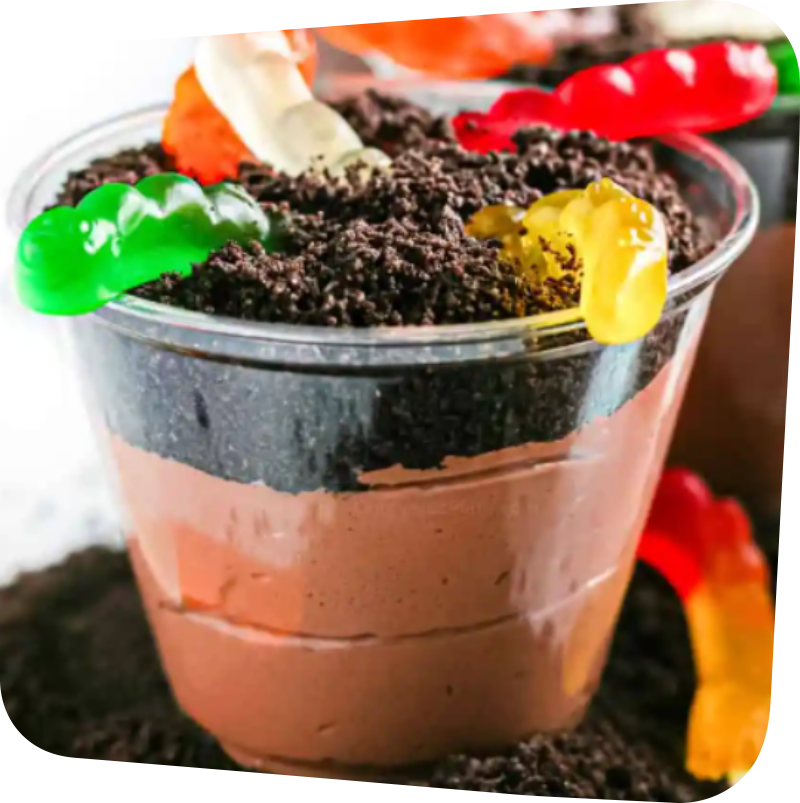 cup filled with chocolate pudding, topped with cookie crumbs and gummy worms