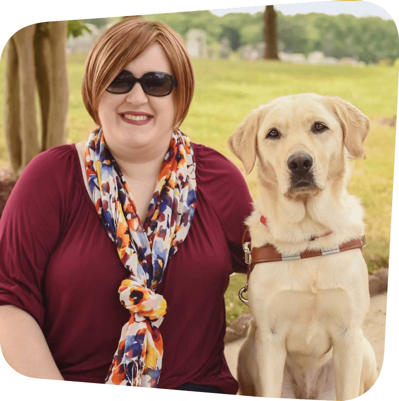Holly Bonner sitting next to her guide dog Frances