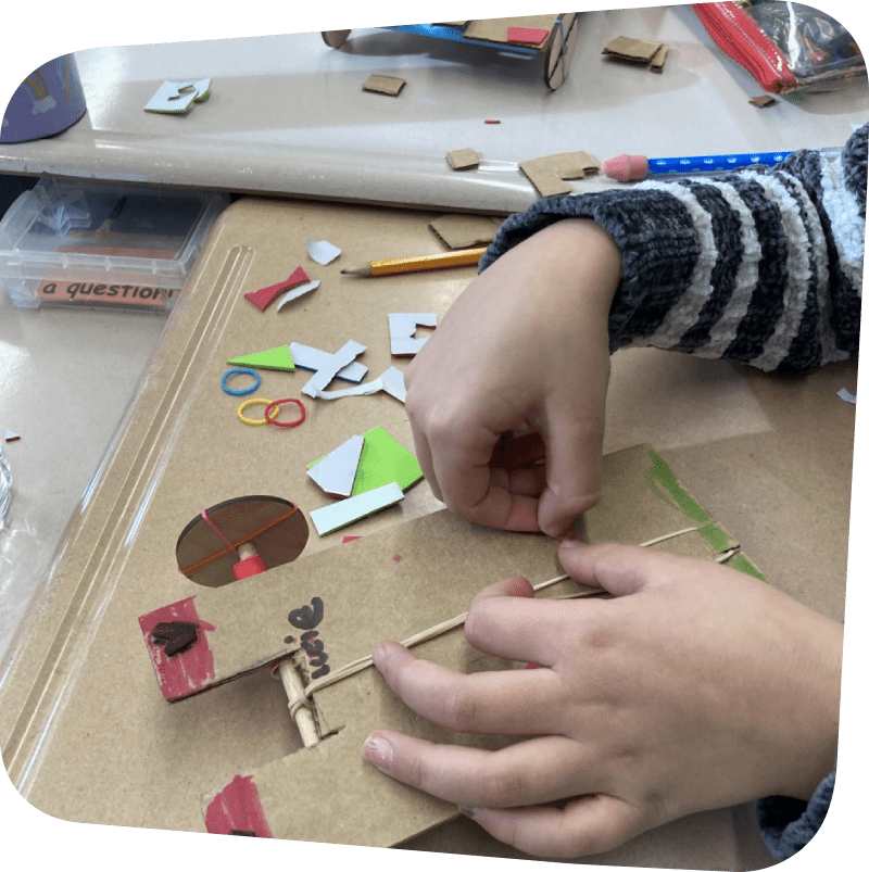 crafters hands making rubberband car