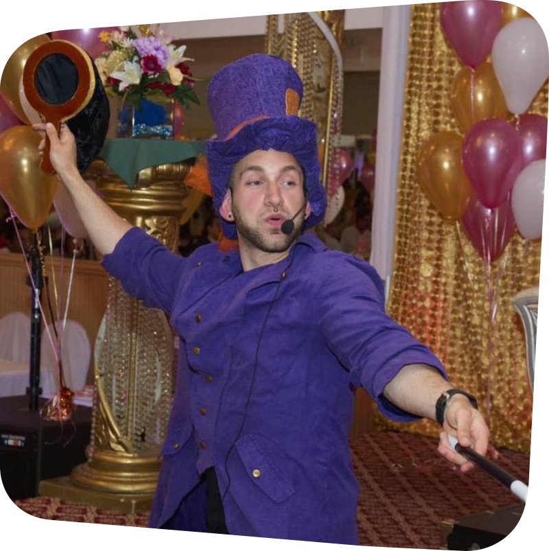 Magician in purple jacket and top hat waving a wand