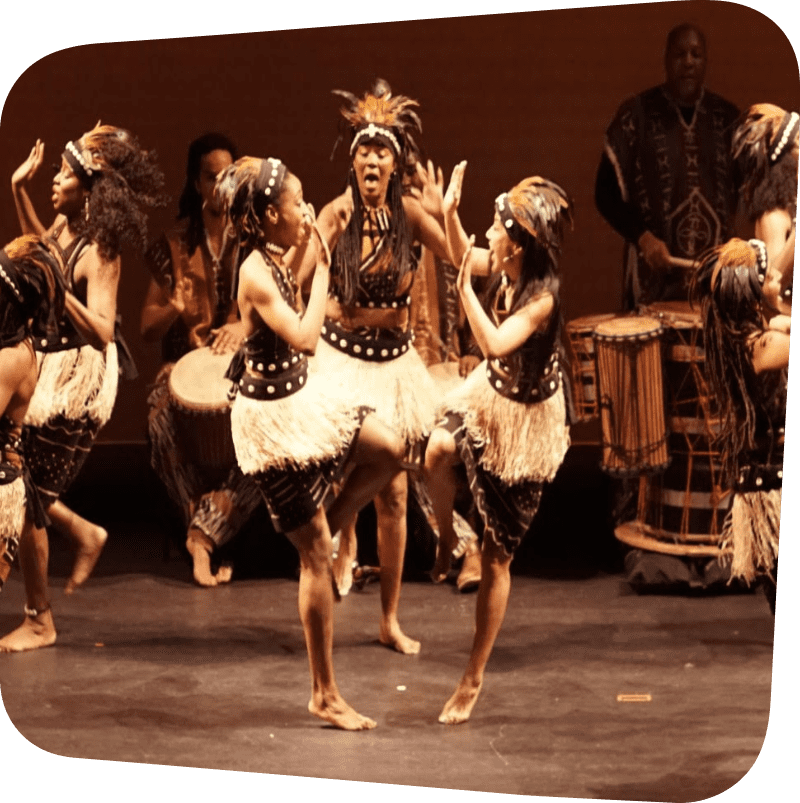 dancers in traditional dress performing dance inspired by African traditions