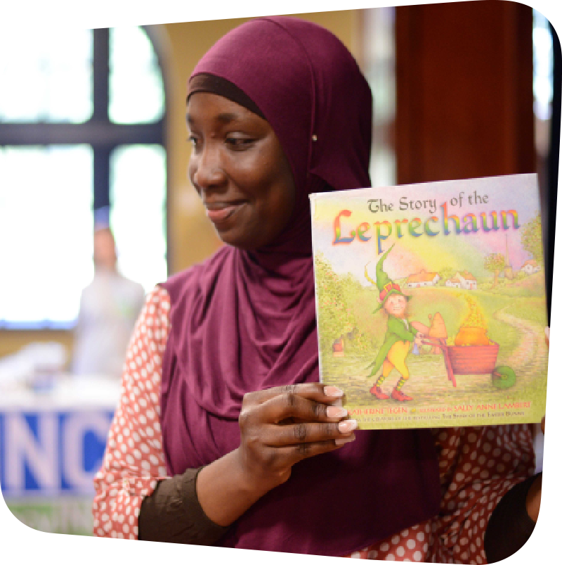 Woman displaying the cover of a children's book