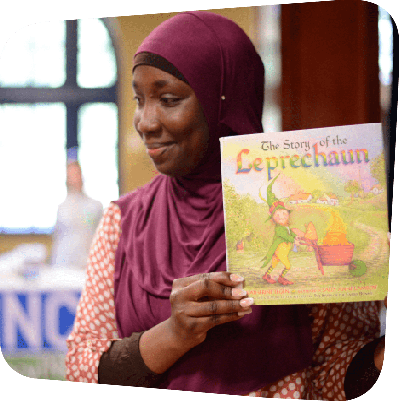 Woman displaying the cover of a children's book