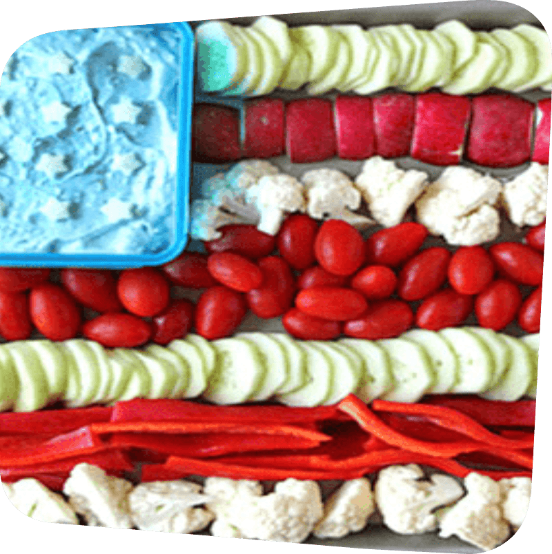 begetables arranged in rows of red and white with a blue corner dip to look like the US flag