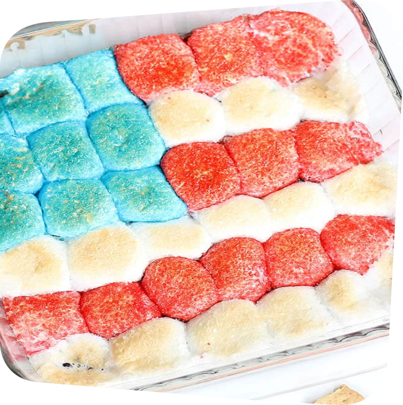 square glass baking dish filled with colored sugar coated marshmallows arranged in the shape of the US flag