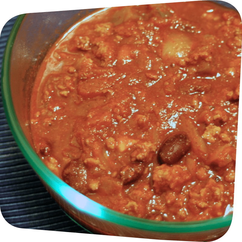 portion of a glass bowl filled with turkey chili