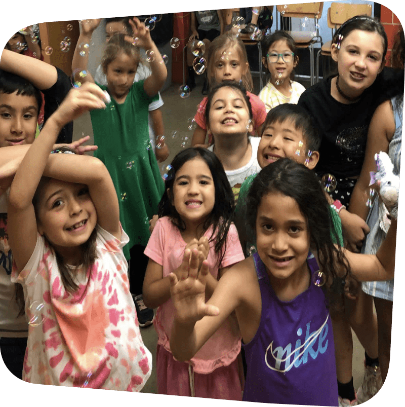children playing with bubbles and smiling