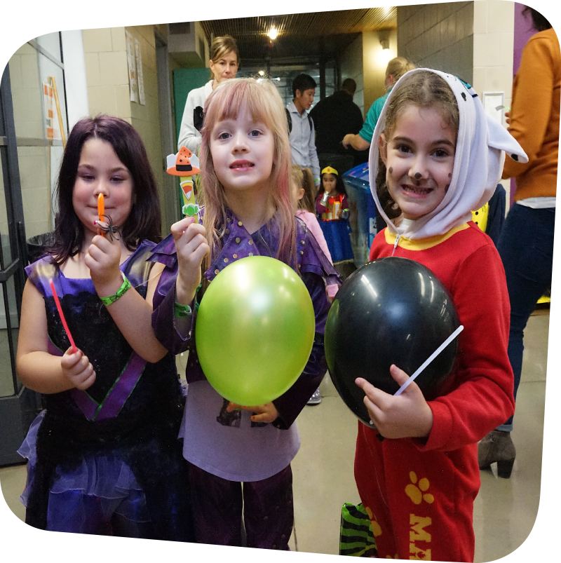 three children in Halloween costumes