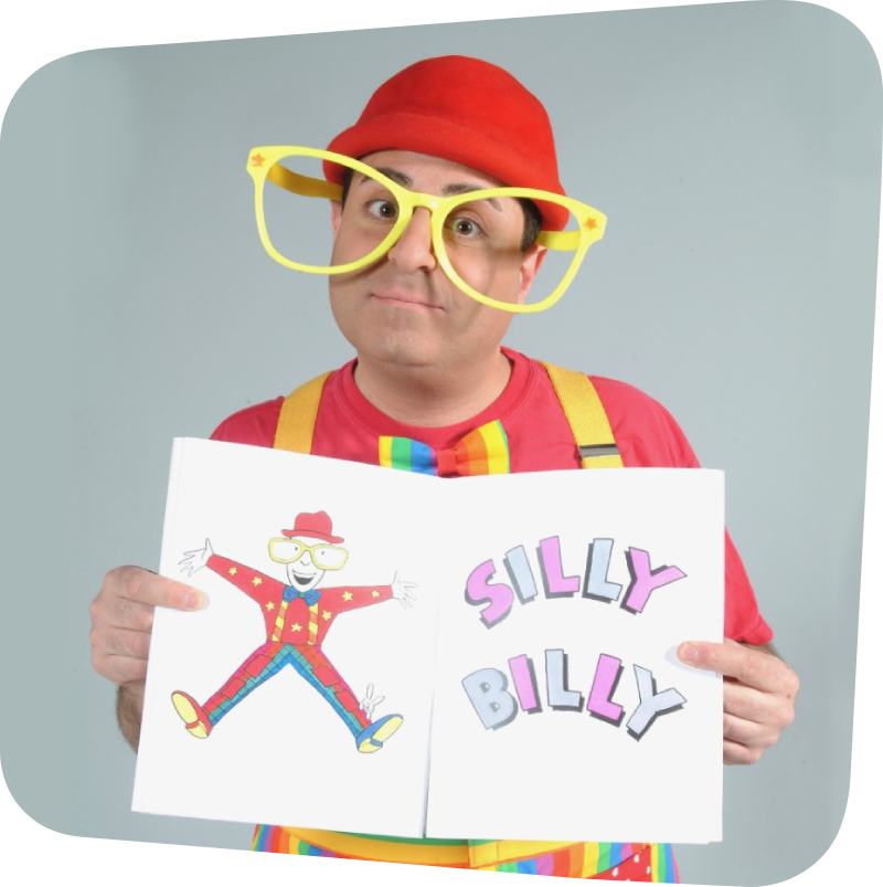 Silly Billy wearing big yellow glasses and a red hat while holding a sign that reads "Silly Billy"