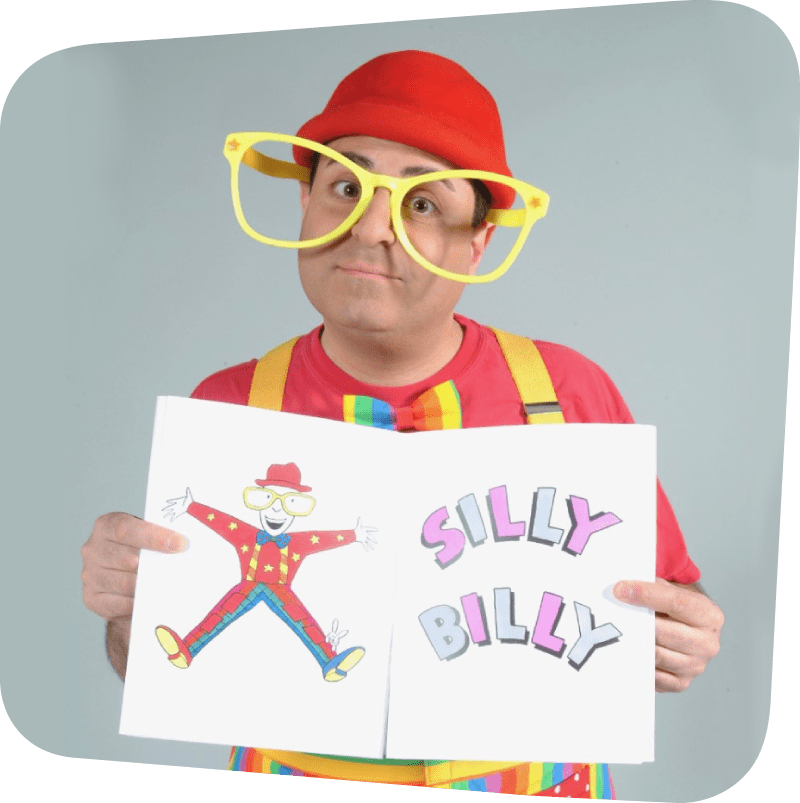 Silly Billy wearing big yellow glasses and a red hat while holding a sign that reads "Silly Billy"