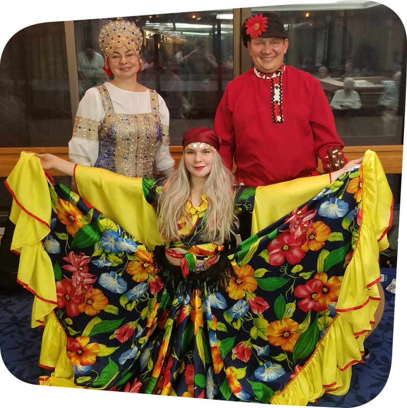 Three adults dressed in traditional Russian clothing