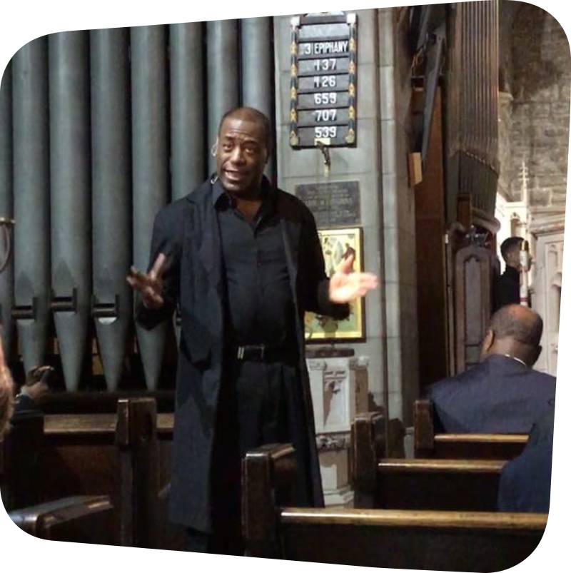 Candid shot of Brocton Pierce talking and standing in front of an audience.