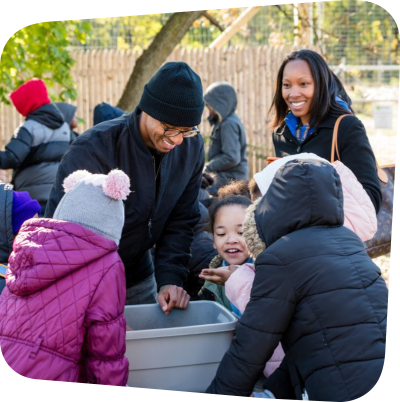 Image of Family gathered around a compost bin