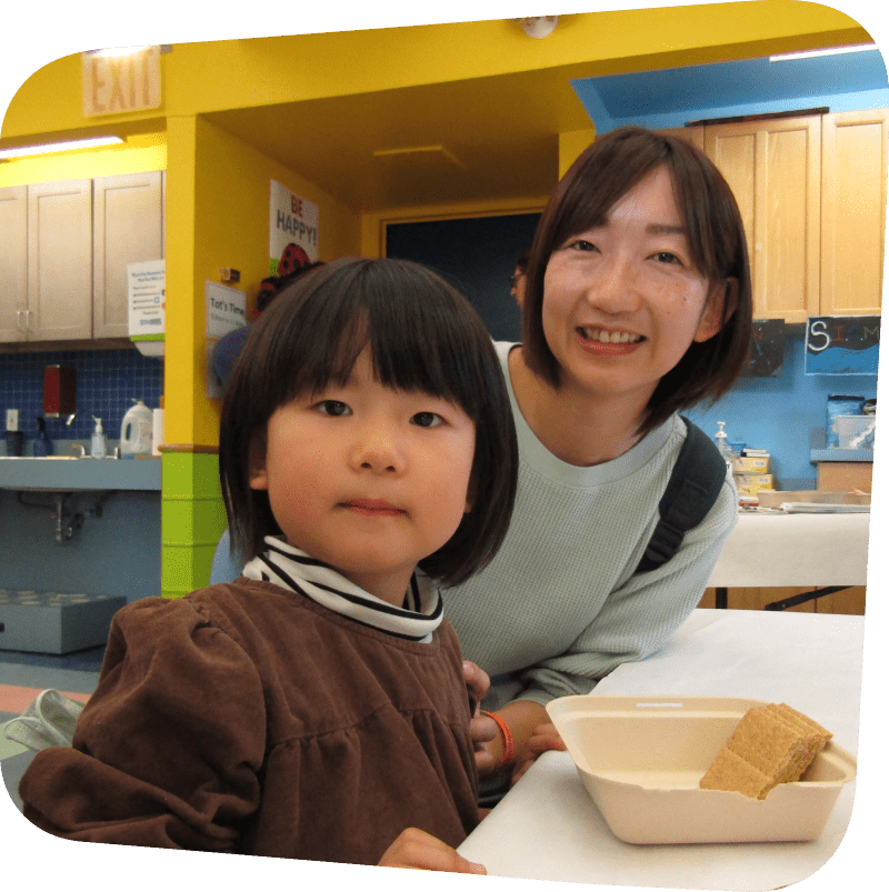 mother and child smiling for camera while prepping Kidz Cook meal