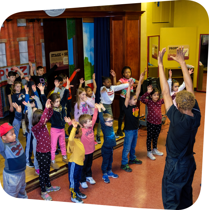A dance class filled with around 15 children being lead by Walter