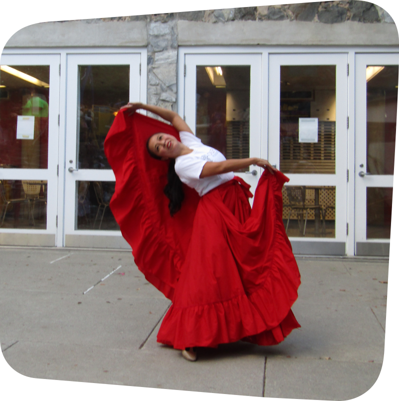 woman in flowing red dress enthusiastically preforming a dance