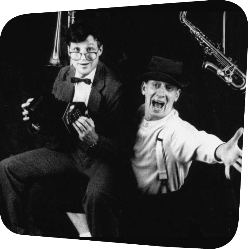 two men featured posing for the photo in dramatic theatrical stances