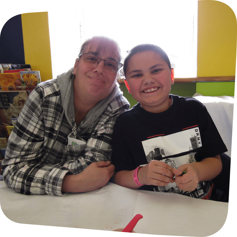 A parent and child featured smiling at the camera