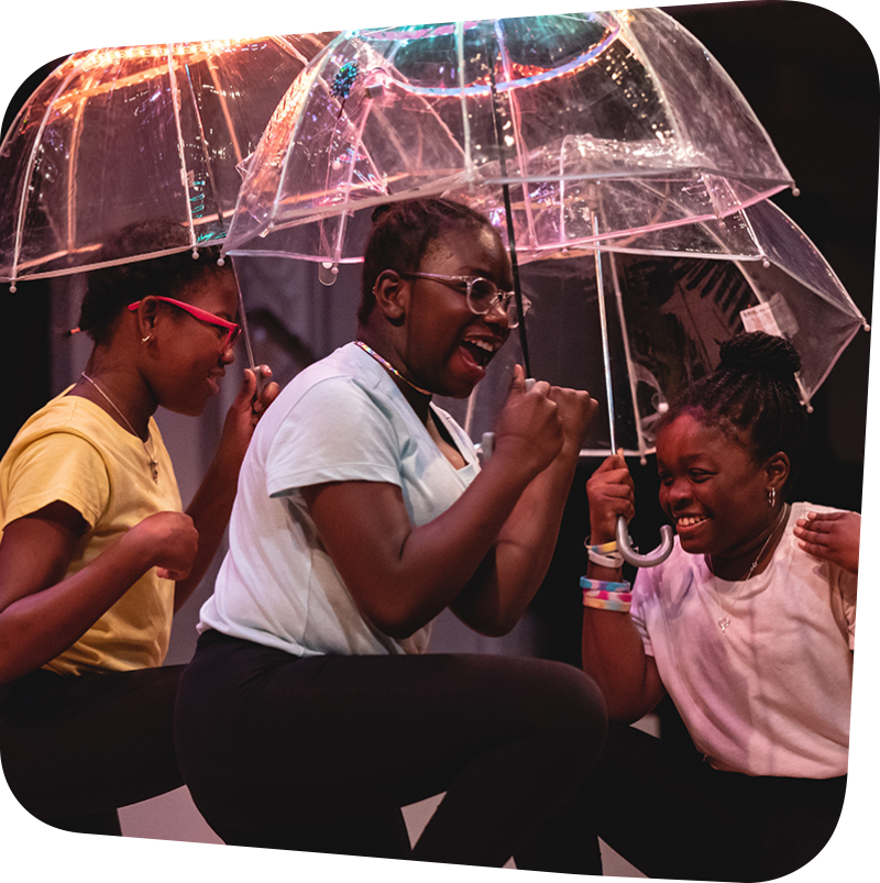 three laughing children featured holding clear umbrellas over their heads