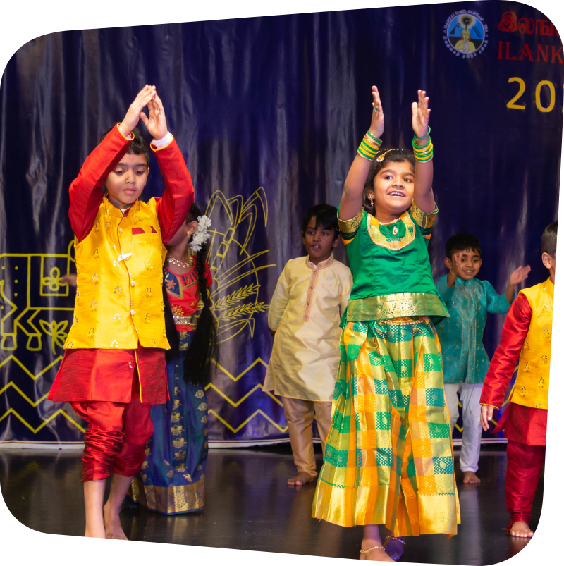 two children in Indian clothing doing a performance