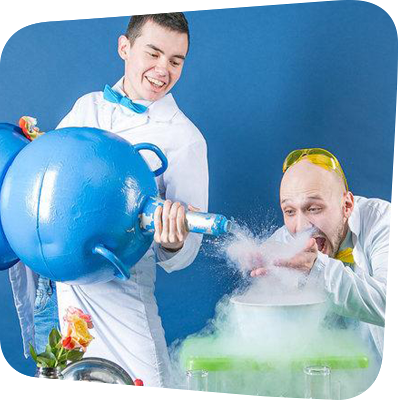 Two silly scientists working with a large container of liquid nitrogen