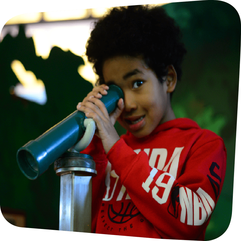 Child looking through spyglass
